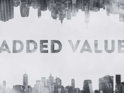 A black and white image with the words added value running through the middle of a city scape