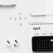 Black and white image of an Iphone calculator and folder stating tax plan.