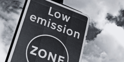 Black and white image of road sign stating low emission zone.