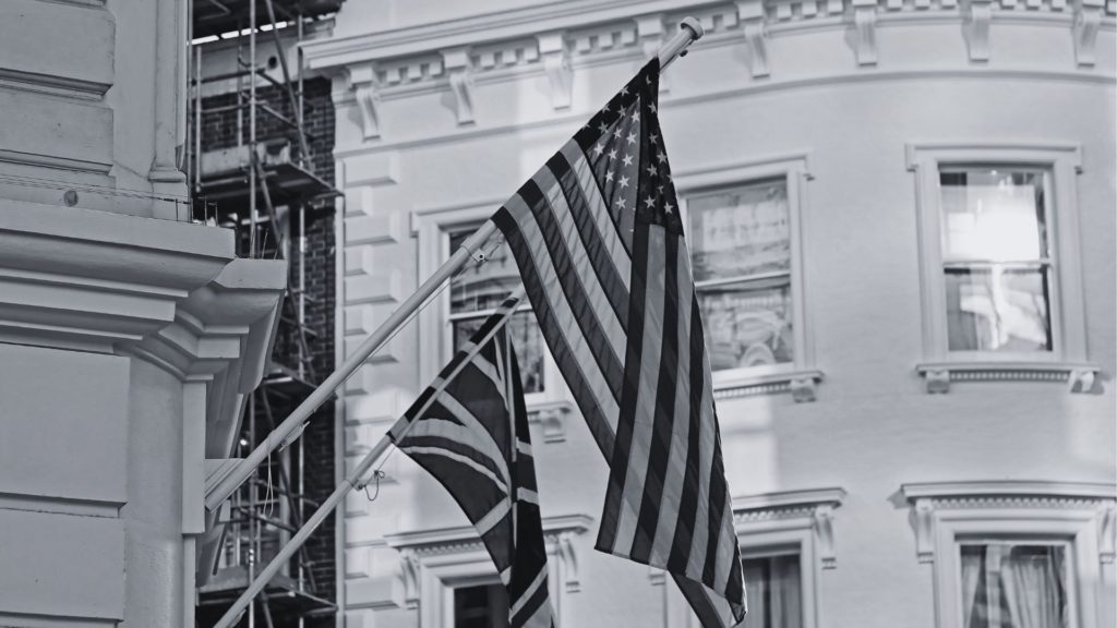 Black and white flag of UK and USA on building