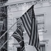 Black and white flag of UK and USA on building