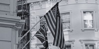 Black and white flag of UK and USA on building