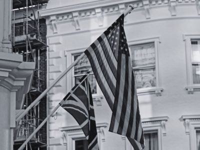 Black and white flag of UK and USA on building