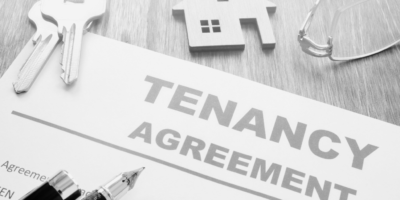 Tenancy Agreement Contract with keys and keyring house in black and white