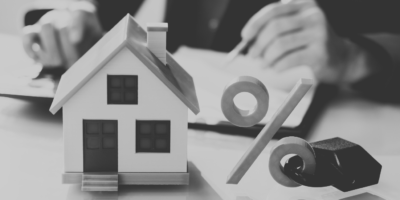 Black and white image with house and percentage symbol with a lock