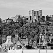 Black and white image of kent with houses and castle on a hill