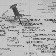 Black and white image of UK Map with pin