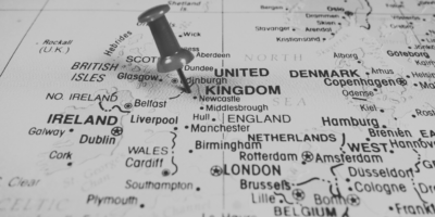 Black and white image of UK Map with pin