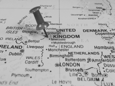 Black and white image of UK Map with pin