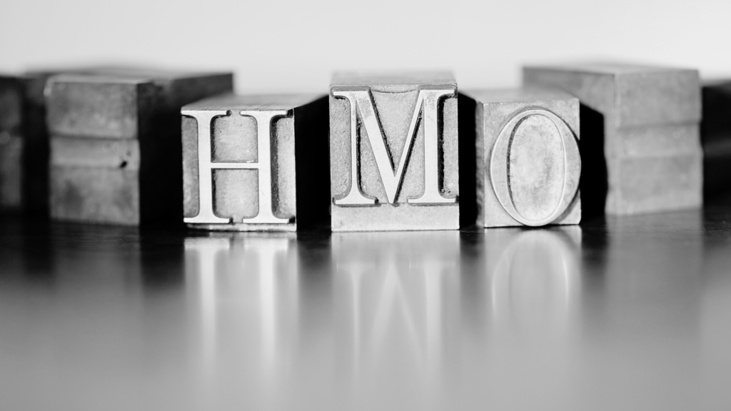 Black and white metal blocks with HMO letters