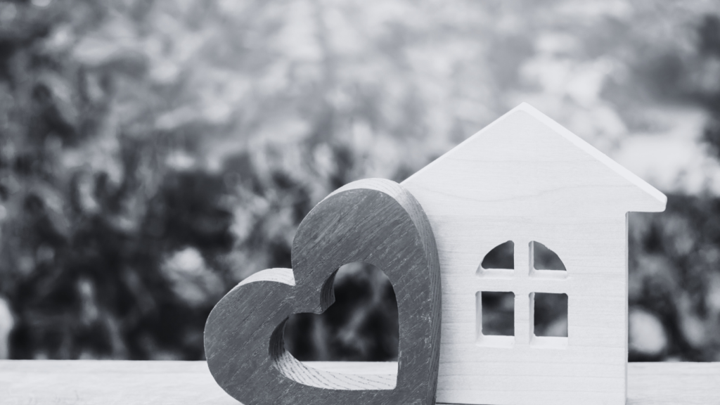 House with heart and shrubs in the background