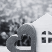 House with heart and shrubs in the background
