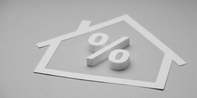 house cut out with percentage sign in black and white