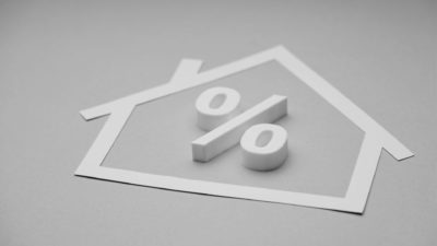 house cut out with percentage sign in black and white