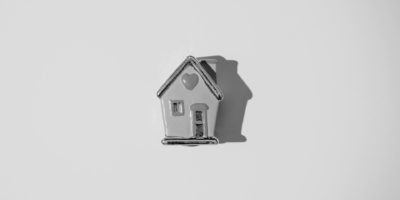 Black and white ceraminc house with heart on the roof