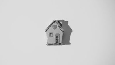 Black and white ceraminc house with heart on the roof