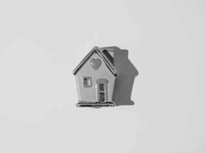 Black and white ceraminc house with heart on the roof