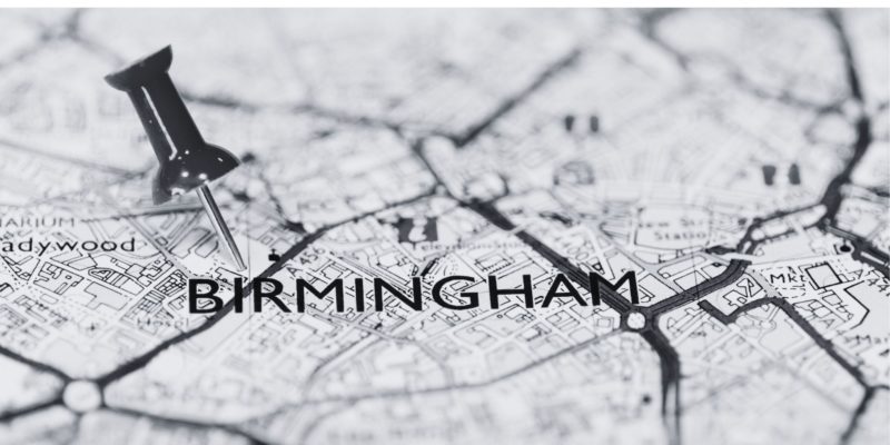 black and white image of map with text Birmingham and pin in the map