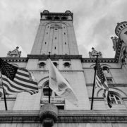 Black and white image of government building with american flags