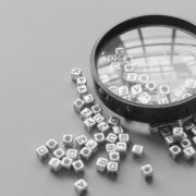 Magnifying glass over scrambled letters