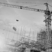 Construction building site with crane in black and white.