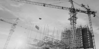 Construction building site with crane in black and white.