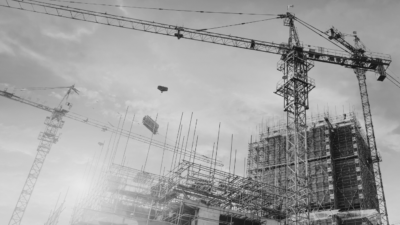 Construction building site with crane in black and white.