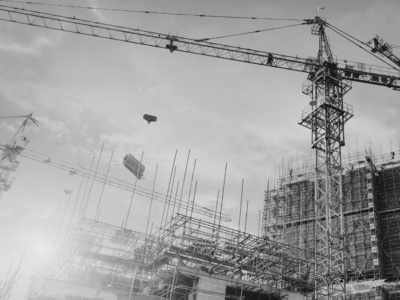 Construction building site with crane in black and white.
