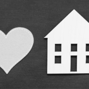 Heart on left with house cut out on right in black and white