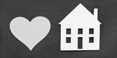 Heart on left with house cut out on right in black and white