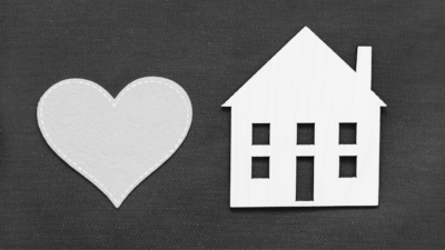 Heart on left with house cut out on right in black and white