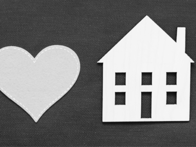 Heart on left with house cut out on right in black and white