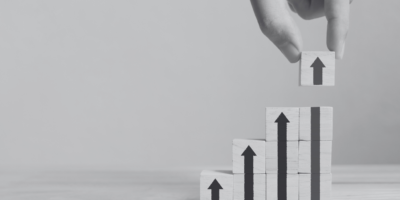 Upward arrows with building blocks pointing up