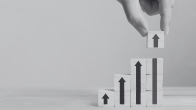Upward arrows with building blocks pointing up