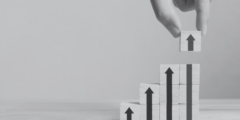Upward arrows with building blocks pointing up