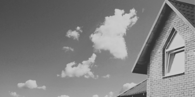 Black and white house with clouds