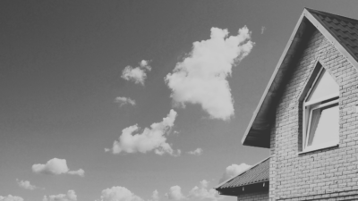 Black and white house with clouds