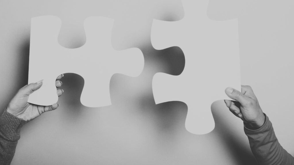 Jigsaw piece fitting together with hands