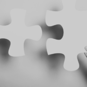 Jigsaw piece fitting together with hands