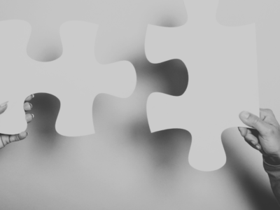 Jigsaw piece fitting together with hands