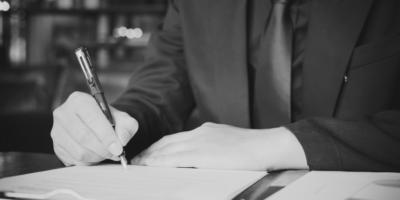 Person writing on document