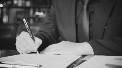 Person writing on document