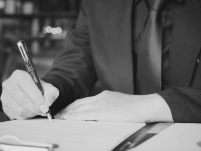 Person writing on document