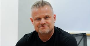 Man sitting on office chair with black jumper