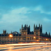 UK Government panoramic view with moving cars in a flash of light in the early evening.
