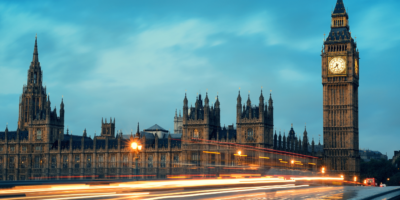 UK Government panoramic view with moving cars in a flash of light in the early evening.