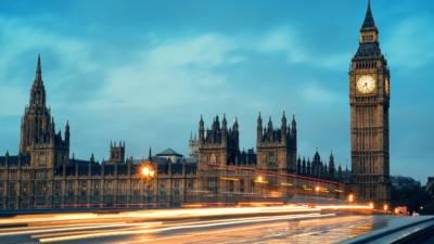 UK Government panoramic view with moving cars in a flash of light in the early evening.