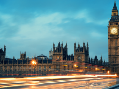 UK Government panoramic view with moving cars in a flash of light in the early evening.