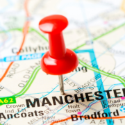 Picture of red pin in paper map on Manchester