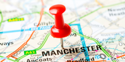 Picture of red pin in paper map on Manchester